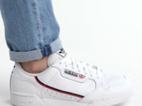 adidas Originals CONTINENTAL 80 - Sneakers low alb worn with jeans, side view showcasing the white leather design.